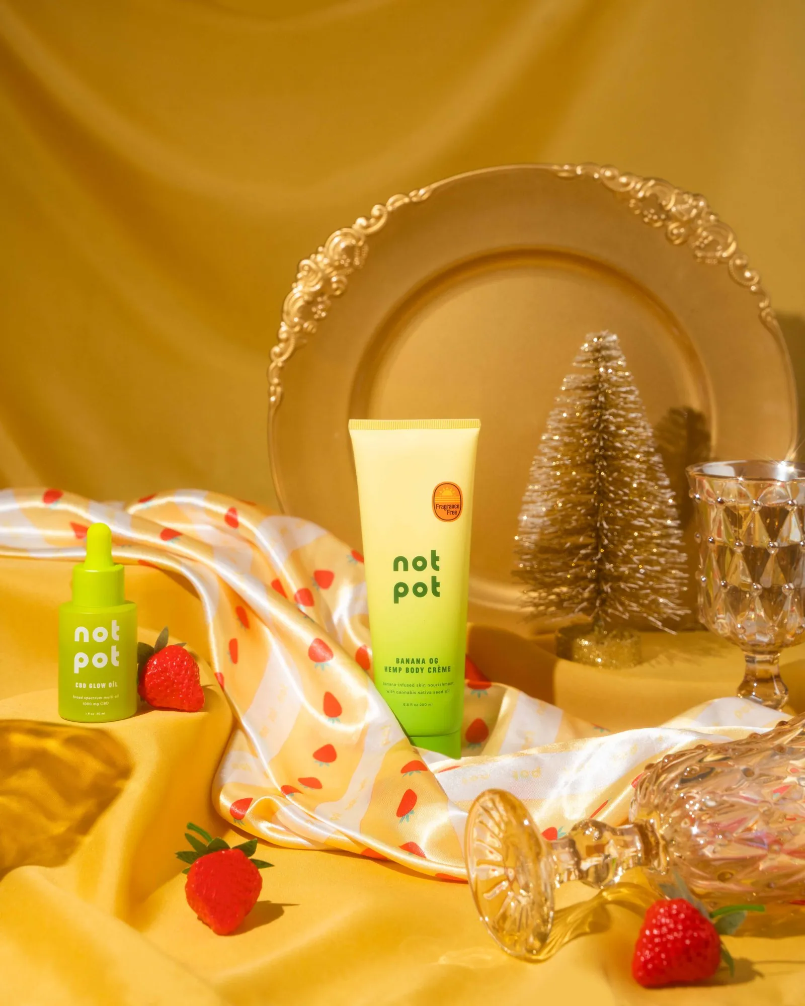 Not Pot tubes on gold satin with a tiny Christmas tree and strawberries